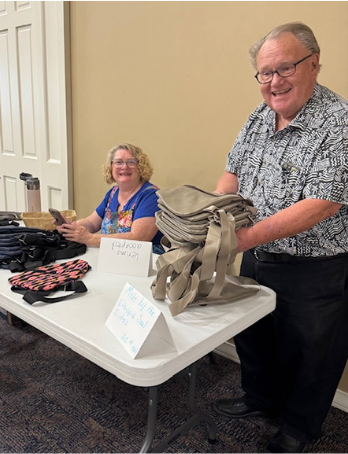 Courtney Block and supporter displaying handmade bags from Ethiopian women